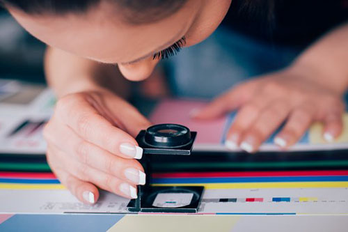 Young woman working in printing factory.